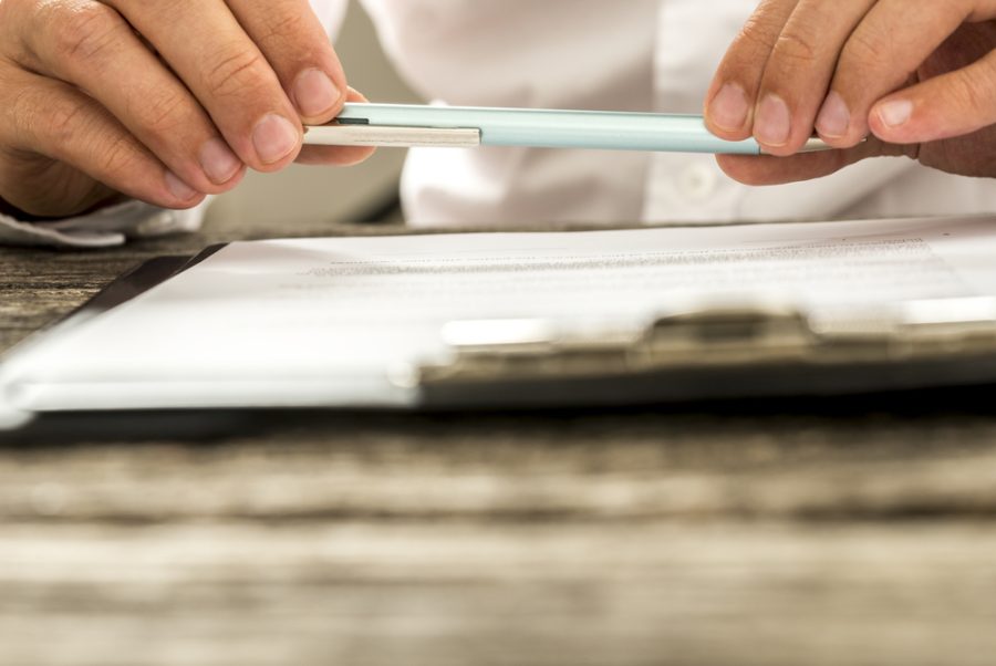 Will and Enduring power of attorney lawyer reviewing paperwork.