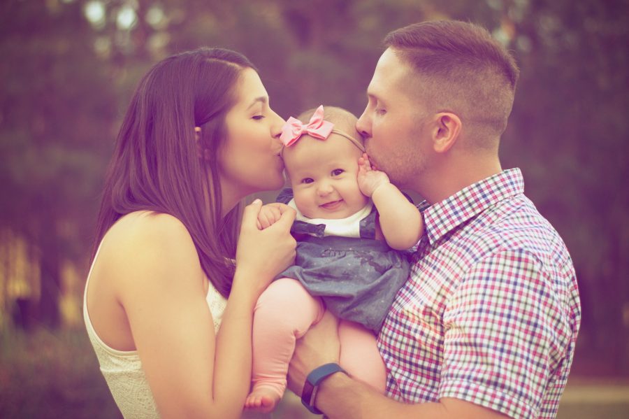 Couple kissing their baby Family Lawyers Adelaide