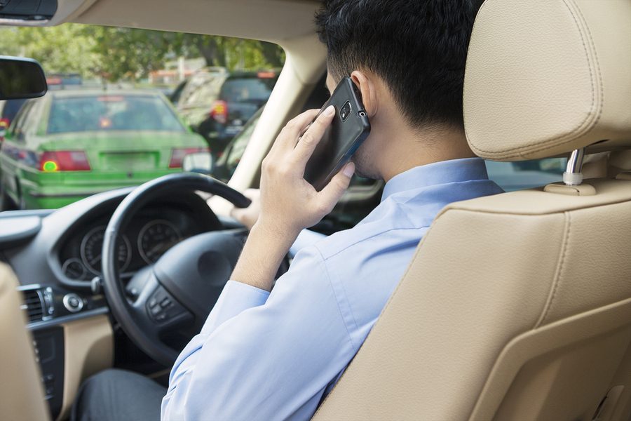 Traffic Lawyers Adelaide man talking on mobile phone while driving.